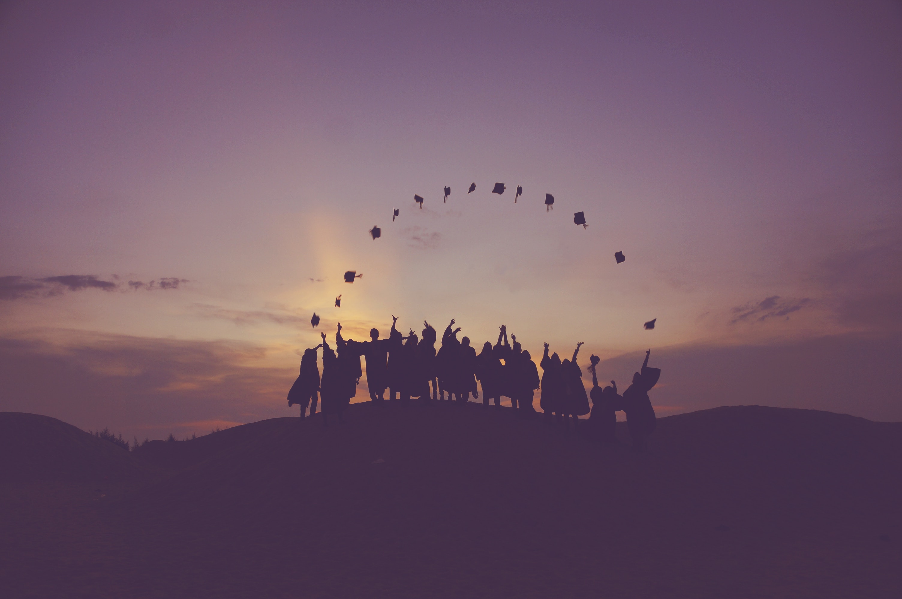 Photo of graduates throwing caps